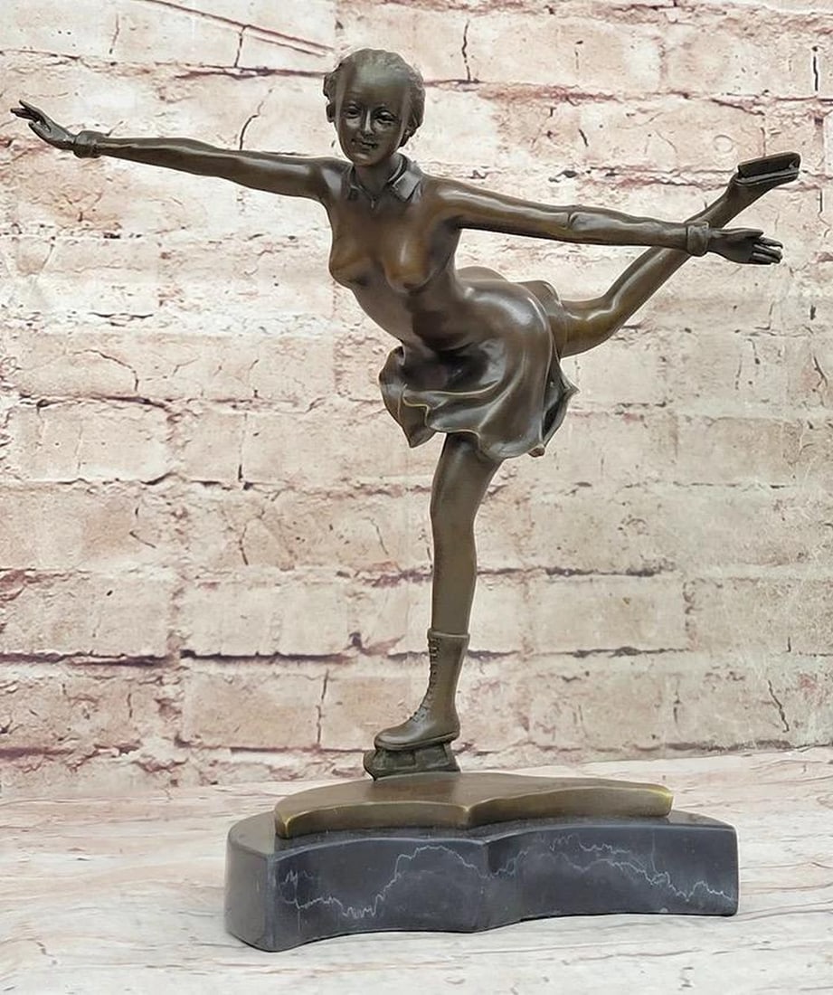 Olympic Figure Skater Inspired Bronze Statue - 12" x 12": Olympic Figure Skater Inspired Bronze Statue - 12" x 12" In a mesmerizing display, a bronze sculpture captures the grace and talent of a lady in motion. Crafted by hand and signed by the artis