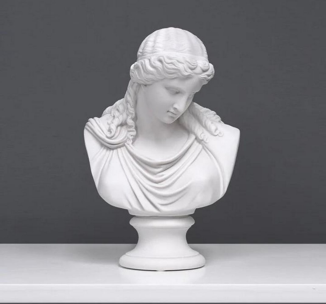 Keeper of Calm: Eirene's Tranquil Bust Sculpture - (7.7lbs): Keeper of Calm: Eirene's Tranquil Bust Sculpture - (7.7lbs) This exquisite marble bust of Eirene, the Greek Goddess of Peace, embodies serenity and harmony. Sculpted with graceful precision, her t
