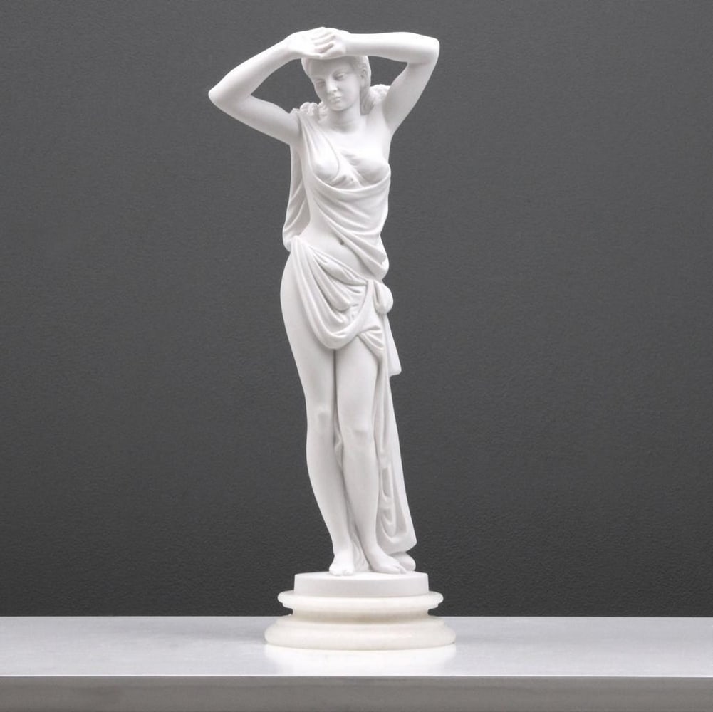 Young Beauty Posing In Toga Sculpture - (2.4lbs): Young Lady Posing in Clothes Sculpture - (2.4lbs) This sculpture portrays a young lady in a toga captured in the act of stretching after bathing. Crafted from white bonded marble, this artwork exhibit