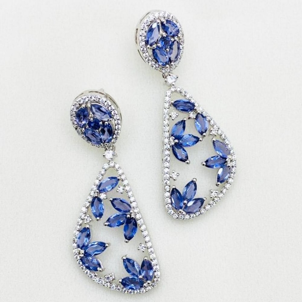 Green Onyx Surrounded by Zirconia in 925 Stirling Silver Earrings: Green Onyx Surrounded by Zirconia in 925 Stirling Silver Earrings These earrings feature green onyx placed in a flower like composition, with zirconia decorating the boarder in a 'tear drop'