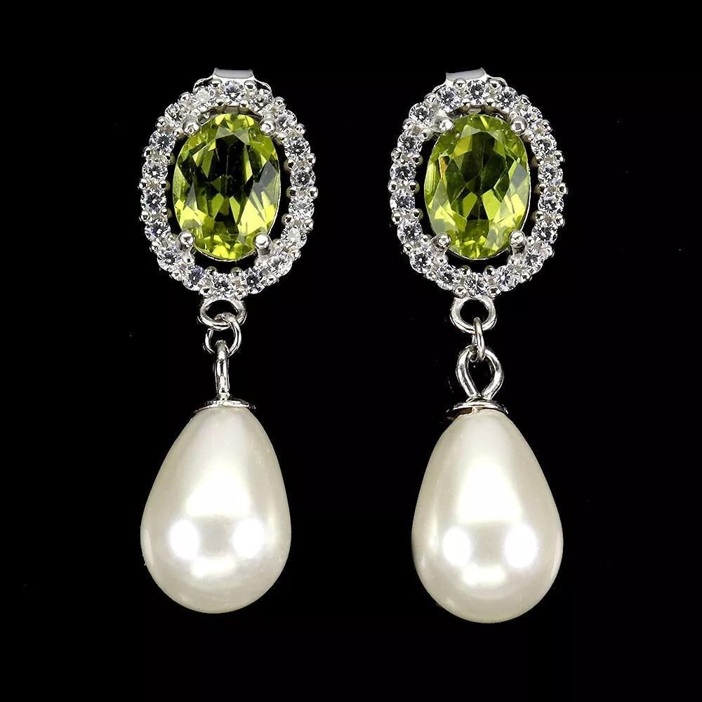 Oval Peridot Gemstone Earrings with Mother-of-Pearl in 925 Sterling Silver: Oval Peridot Gemstone Earrings with Mother-of-Pearl in 925 Sterling Silver These stunning earrings showcase natural oval peridot gemstones set against a backdrop of lustrous mother-of-pearl in 925 ste