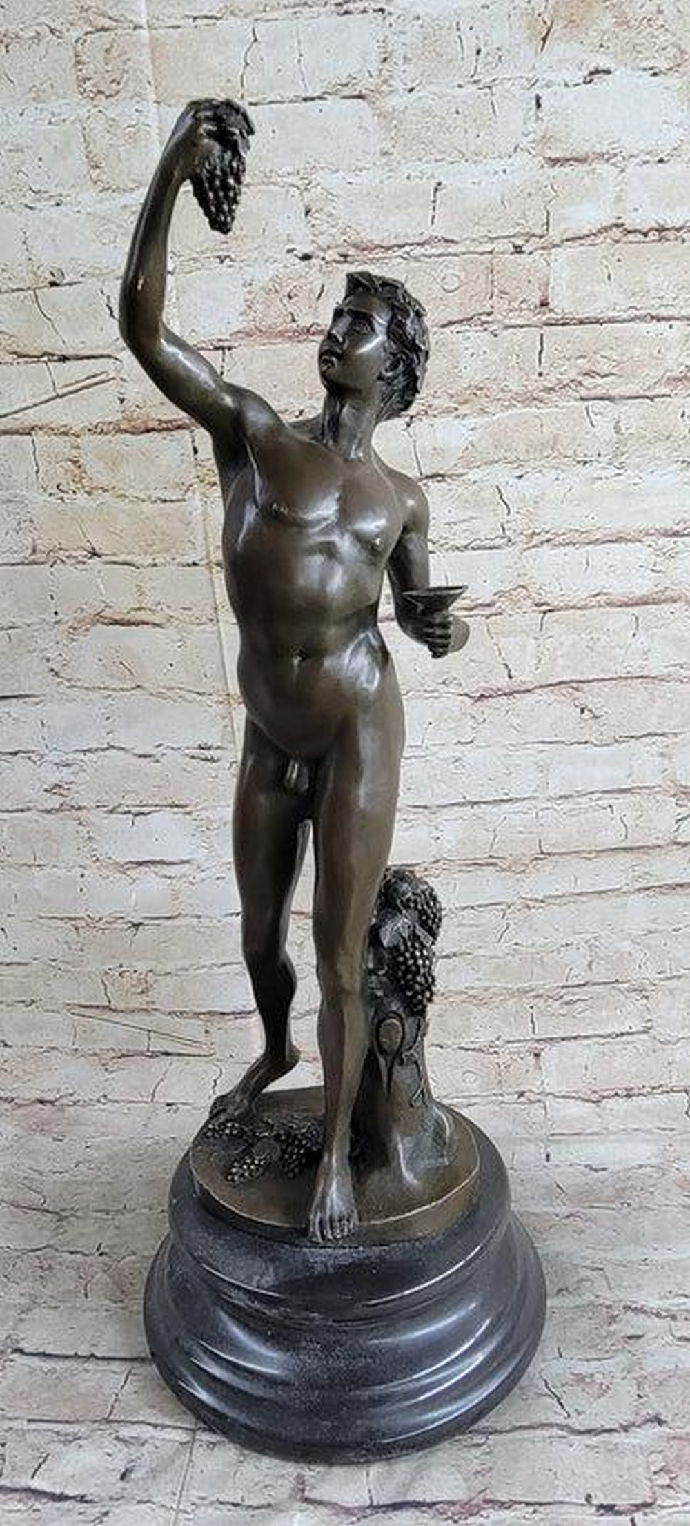 Harvest God Dionysus Inspired Bronze Sculpture - 22" x 8": Harvest God Dionysus Inspired Bronze Sculpture - 22" x 8" This captivating bronze sculpture embodies the youthful and nude essence of Dionysus, the revered Greek god linked to grape harvest, w