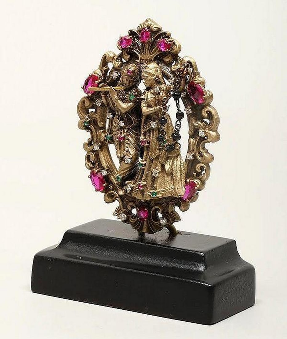 Radha and Krishna Mini Brass Statue with Base: Radha and Krishna Mini Brass Statue with Base This 3" brass statue depicts Radha and Krishna, symbolizing divine love and devotion. Krishna, flute in hand, stands beside Radha, with intricate deta