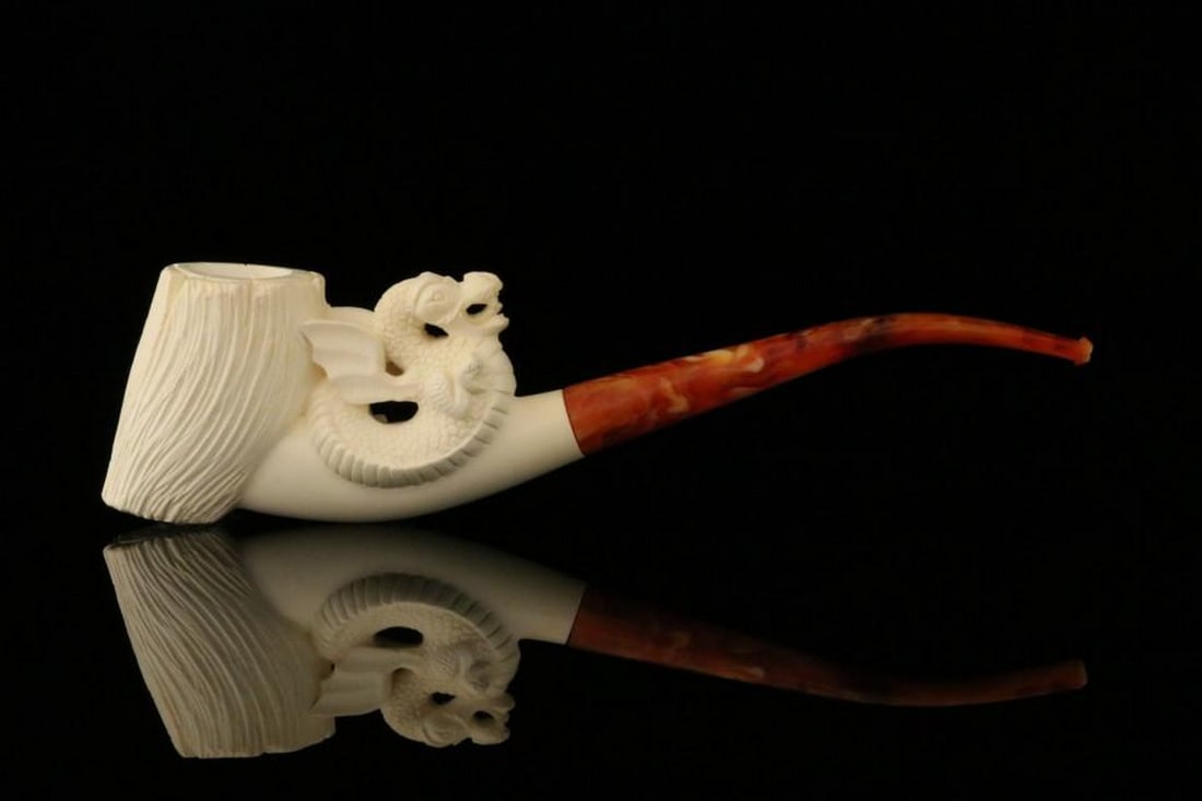 Hand-Carved Dragon Meerschaum Pipe with Fitted Case: Hand-Carved Dragon Meerschaum Pipe with Fitted Case This striking Dragon Meerschaum Pipe comes with a fitted case, featuring detailed dragon carvings that highlight the natural elegance of meerschaum.