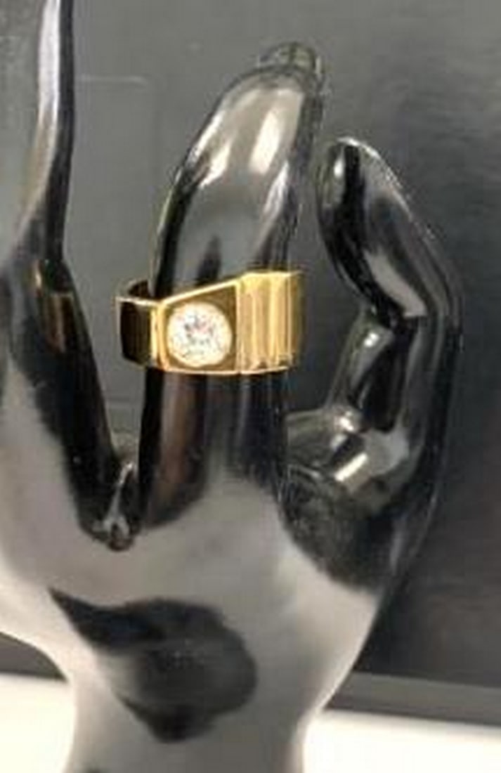 Golden Brilliance: Classic Solitaire Ring with Round-Cut Stone: Golden Brilliance: Classic Solitaire Ring with Round-Cut Stone A stunning embodiment of elegance, this gold ring showcases a prominent round-cut center stone set atop a wide, polished band. The sleek