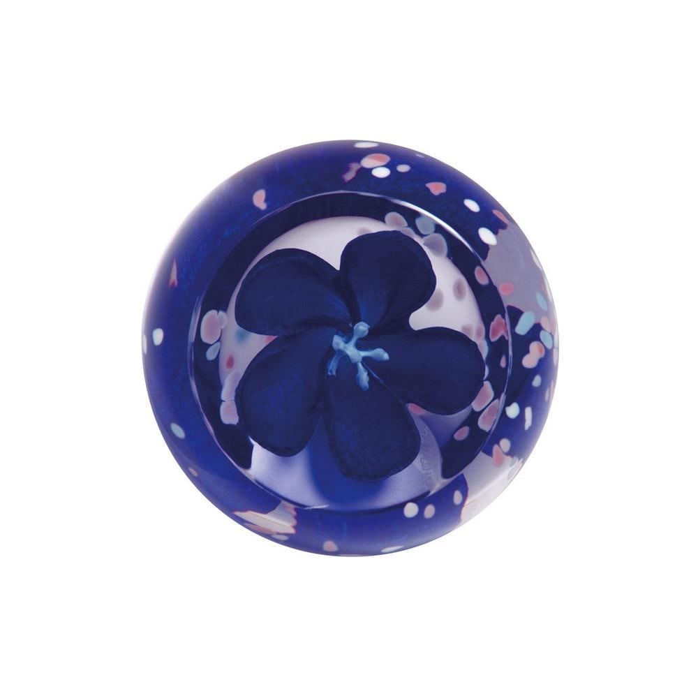 Frozen Blossom in Sapphire Paperweight: Frozen Blossom in Sapphire Paperweight A handmade glass paperweight featuring delicate blossoms in soft blue tones, created using the millefiori technique. The intricate petals and leaves gracefully