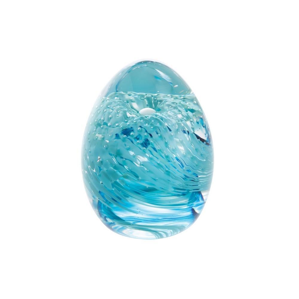 Aqua Swirl Glass Paperweight: Aqua Swirl Glass Paperweight A handcrafted glass paperweight featuring flowing abstract swirls of aqua blue and turquoise suspended within a clear dome. Its smooth, polished surface catches the