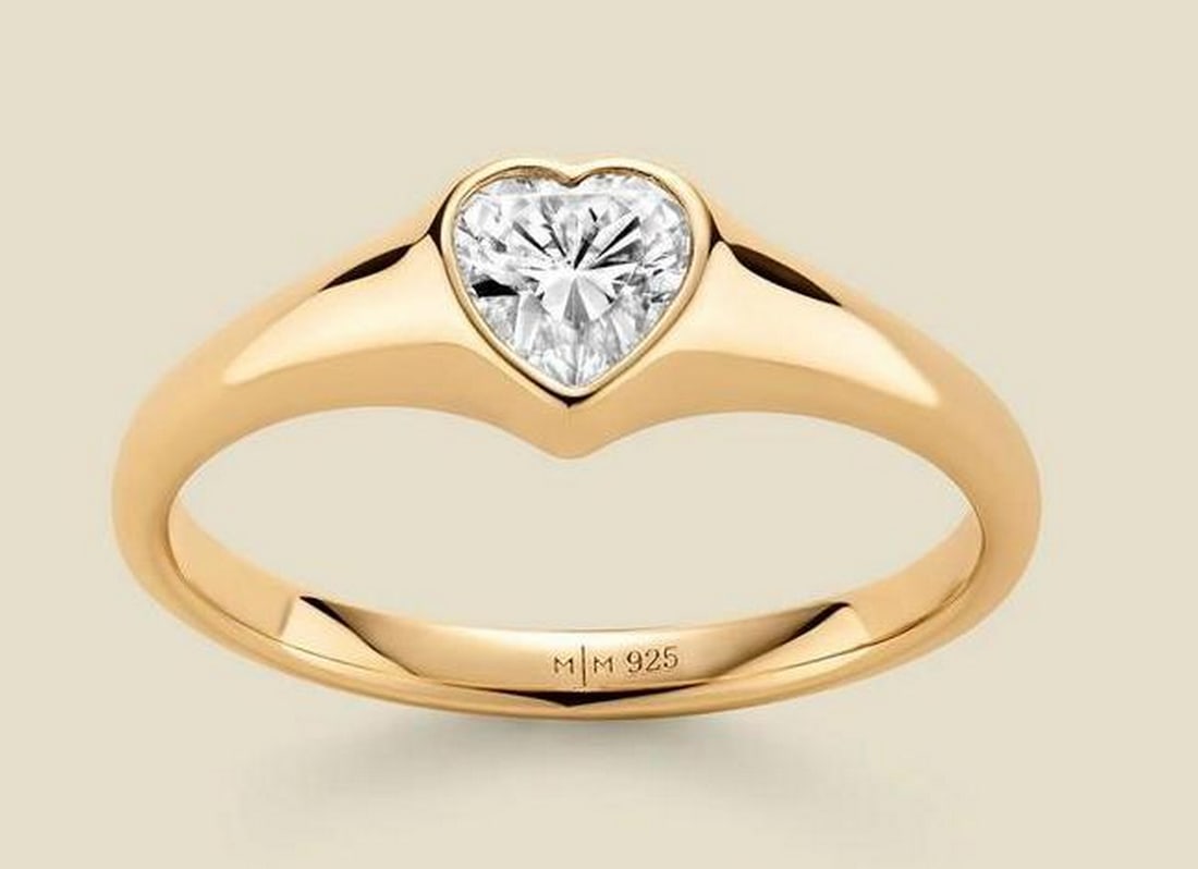 Gold Vermeil CZ Heart Ring: Gold Vermeil CZ Heart Ring A modern heart-shaped ring featuring a bezel-set cubic zirconia at its center, subtle yet striking—a quiet declaration of love. Smooth, sculpted edges give the piece a pol