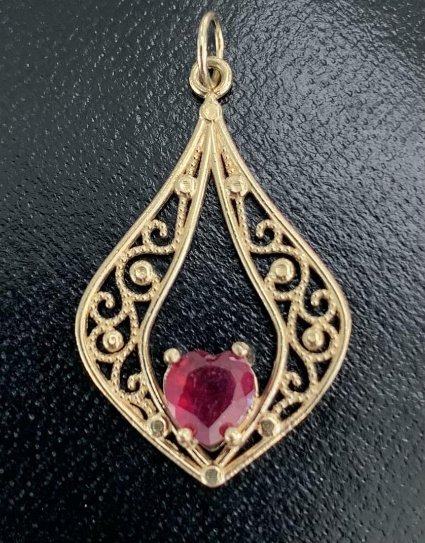 Luminous Ruby Pendant in 14KT Gold: Luminous Ruby Pendant in 14KT Gold Radiating timeless romance, this exquisite pendant features a vibrant 0.8ct heart-shaped ruby set at the center of a beautifully crafted 14KT gold frame weighing