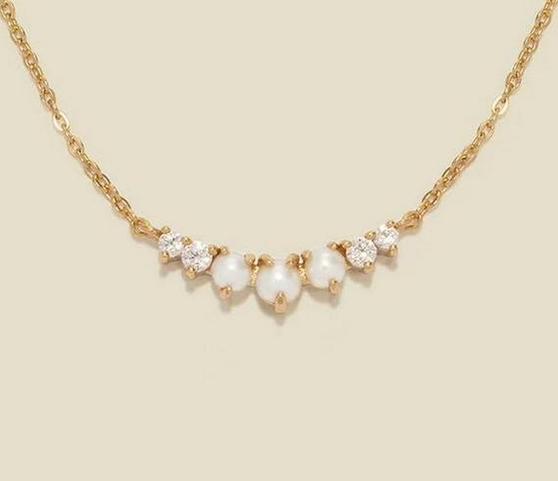Luminous Crescent Pearl Necklace: Luminous Crescent Pearl Necklace Embrace timeless elegance with this gracefully understated necklace. A fixed crescent of graduated freshwater pearls is beautifully enhanced by the subtle sparkle of