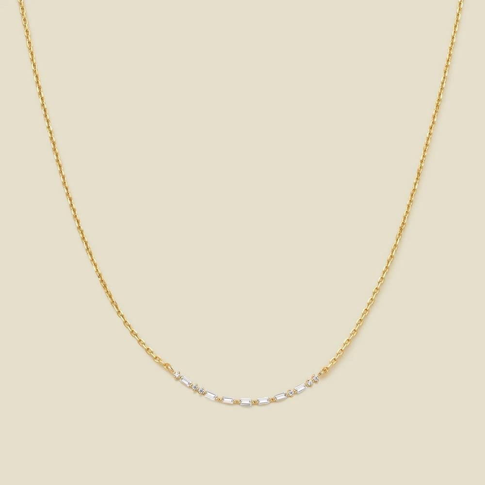 Crescent Morse Code Gold Vermeil Necklace: Crescent Morse Code Gold Vermeil Necklace This elegant crescent necklace is a unique expression of love and connection. Crafted with precision, it features baguette and gem CZs arranged as Morse Code