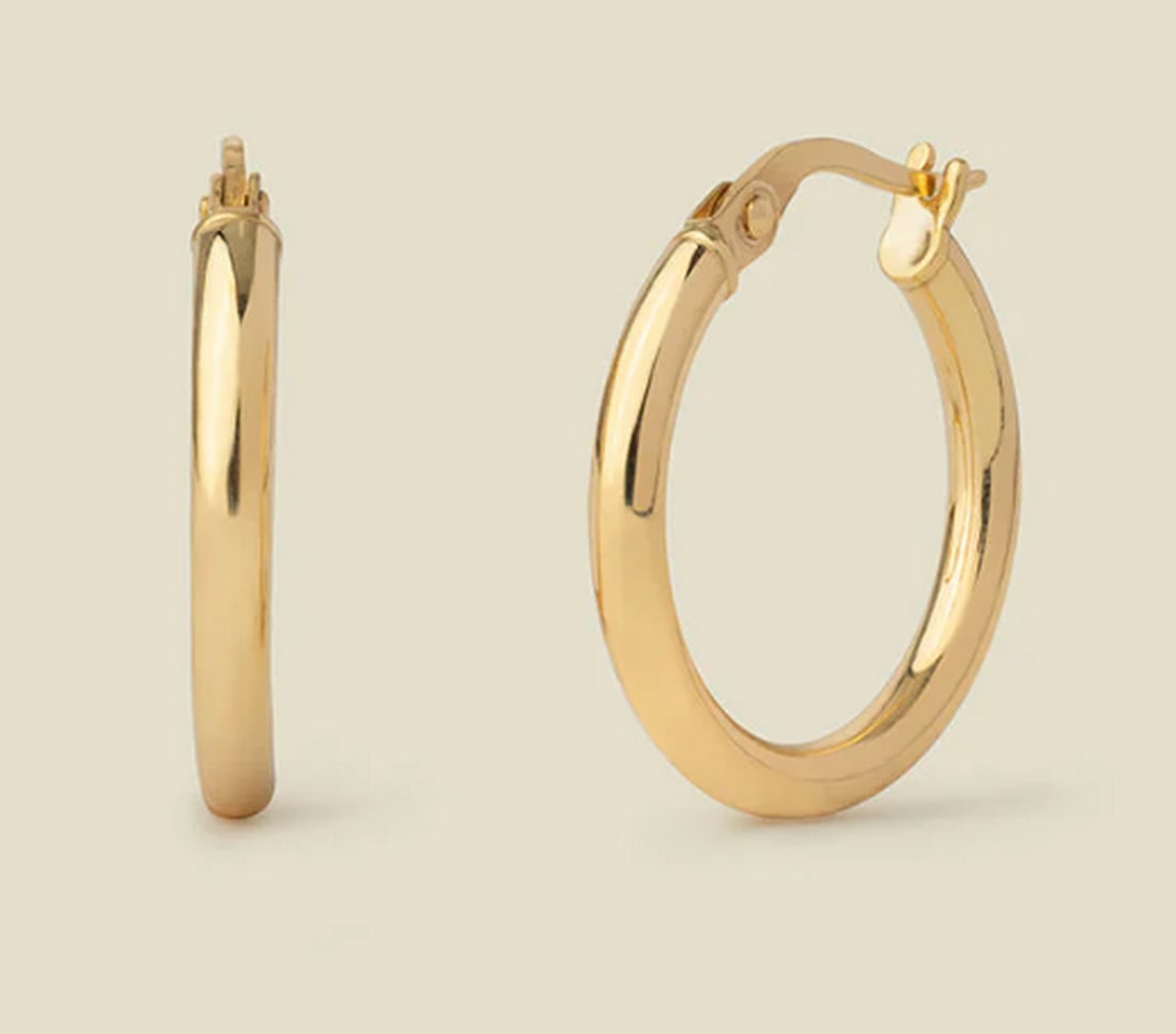 14k Solid Gold Maude Hoop Earrings: 14k Solid Gold Maude Hoop Earrings Elevate every moment with the timeless shine of these 14k solid gold hoops. With a lightweight feel and hinge-style closure, these essential hoops add a radiant