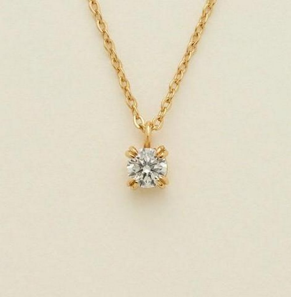 Lustre Solitaire Necklace: Lustre Solitaire Necklace A single shimmering cubic zirconia graces this delicate chain, capturing light with every movement. Timeless and refined, this necklace is a radiant symbol of inner strength