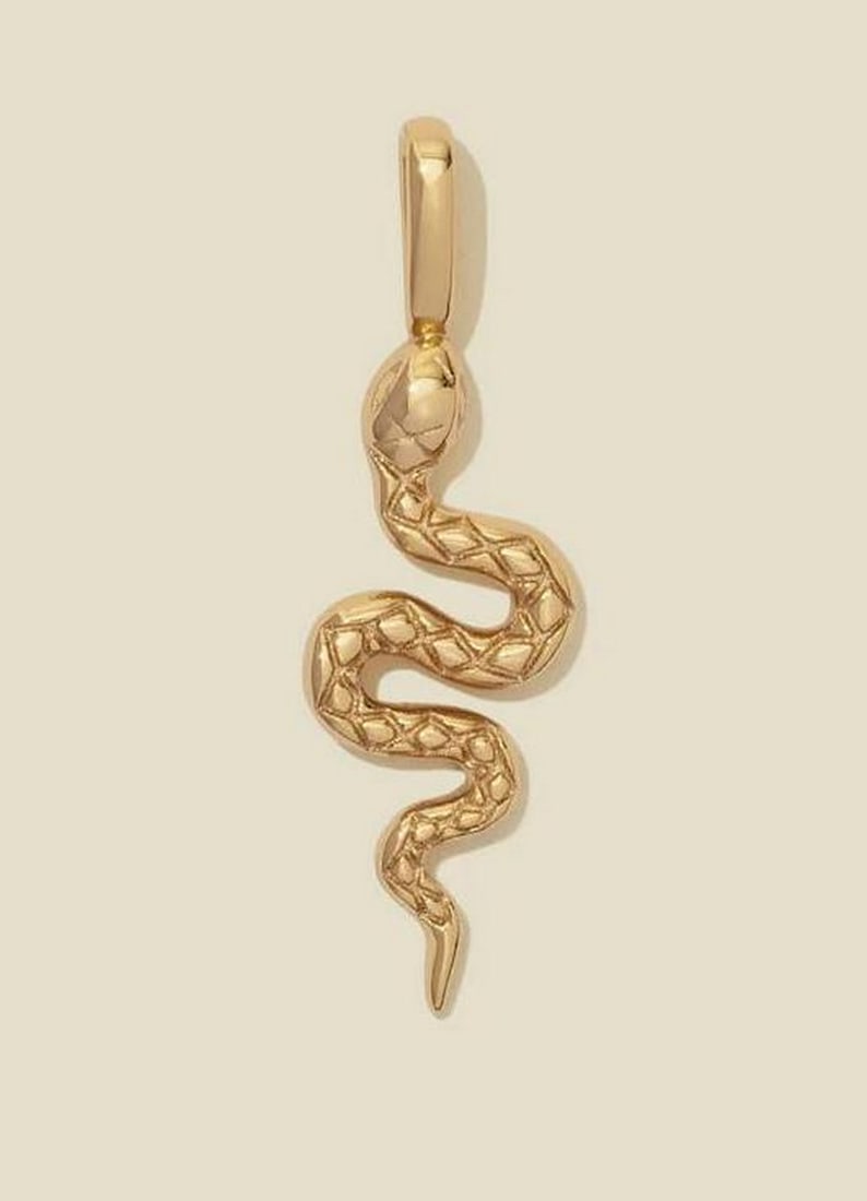 Vermeil Gold Snake Charm Pendant: Vermeil Gold Snake Charm Pendant Start your journey of renewal with the captivating Snake Charm. Crafted in gold vermeil, this intricately detailed symbol grounds you in self-love and helps reconnect