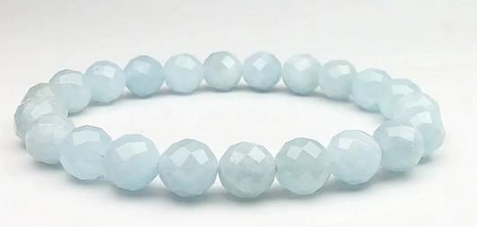 Blue Tranquility Aquamarine Bracelet: Blue Tranquility Aquamarine Bracelet Inspired by the tranquil waters of the ocean, this aquamarine faceted beaded bracelet features shimmering beads that catch the light with every movement. Known