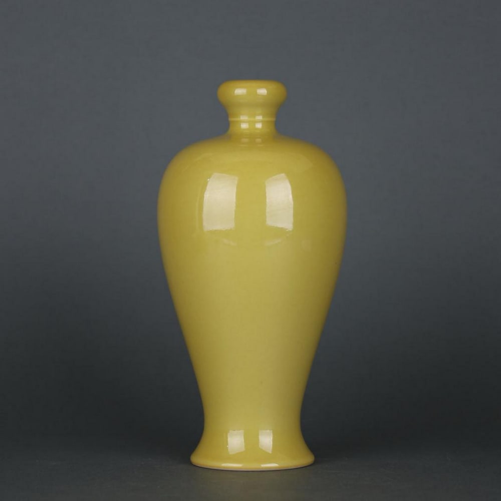 Yellow Glazed Garlic-Head Bottle with Yongzheng Mark: Yellow Glazed Garlic-Head Bottle with Yongzheng Mark A luminous yellow-glazed porcelain bottle, notable for its garlic-shaped mouth and elegant, slender form. The glaze is smooth and even, radiating a