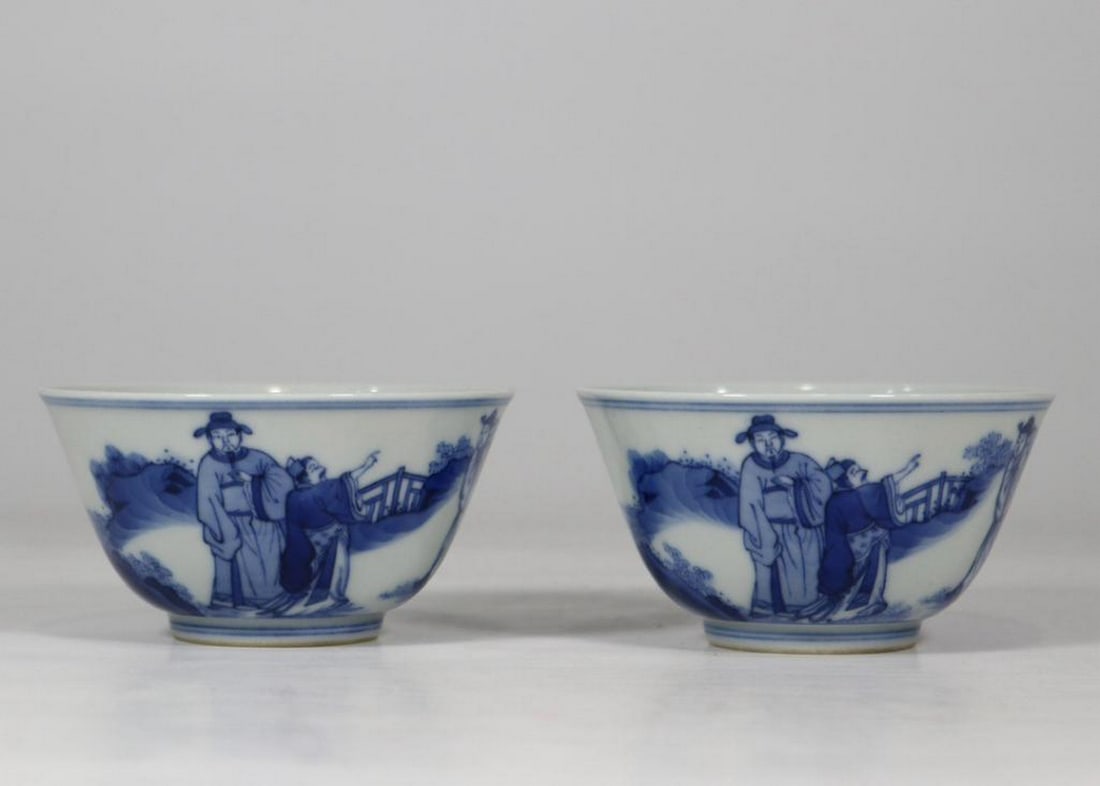 Pair Of Qing Kangxi-Inspired Storytelling Cups: Pair Of Qing Kangxi-Inspired Storytelling Cups. This intricately designed pair of cups draws inspiration from the Qing Dynasty's Kangxi period (1662–1722), featuring detailed illustrations that 