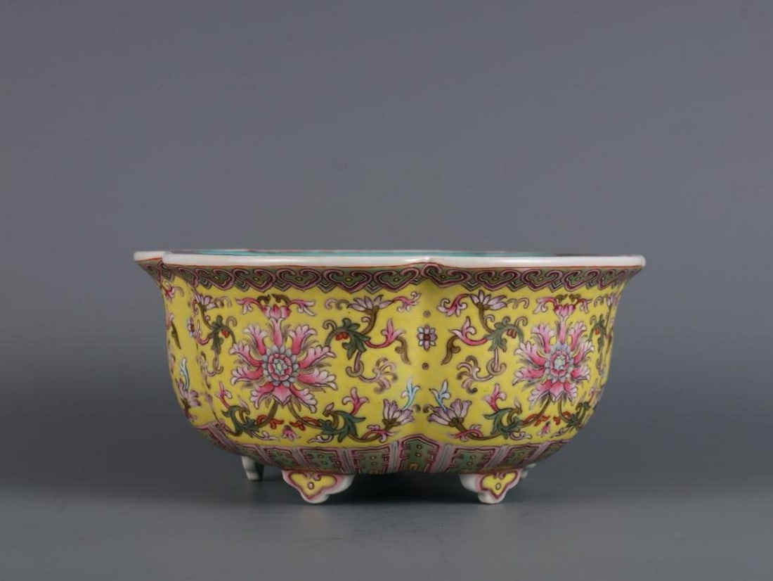 Inspired Qianlong Yellow Ground Famille Rose Flower Pot: Inspired Qianlong Yellow Ground Famille Rose Flower Pot This inspired flower pot from the Qianlong period of the Qing Dynasty features a vibrant yellow ground adorned with intricate famille rose flora