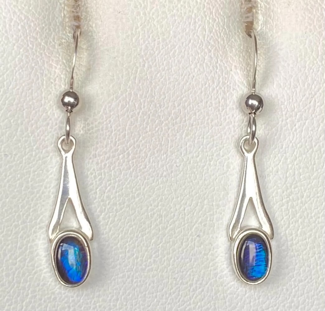 Petite Blue Ammolite Earrings: Petite Blue Ammolite Earrings This is a set of Ammolite earrings with petite blue gems. Although the blue is pretty good, they are not quite as bright as the photos. Blue is very difficult to capture 