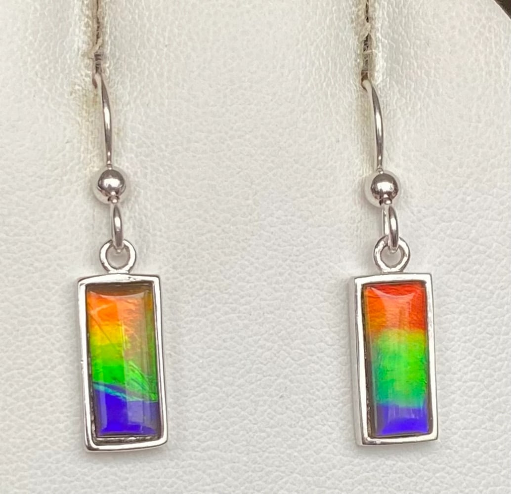Multi-colour Ammolite Earrings: Multi-colour Ammolite Earrings These earrings feature 12mm x 5mm low-dome quartz-capped triplets set in rhodium-plated sterling silver for a tarnish-resistant finish. Hanging from matching rhodium-pla