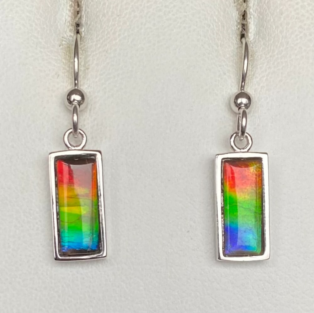 Multi-colour Ammolite Earrings: Multi-colour Ammolite Earrings These earrings feature 12mm x 5mm low-dome quartz-capped triplets, set in rhodium-plated sterling silver for a tarnish-resistant finish. Suspended from matching
