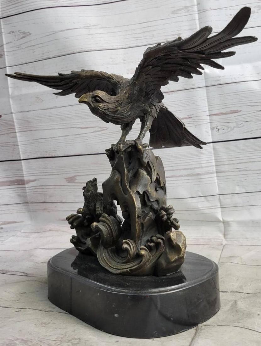 Original Eagle Landing on Waves Bronze Sculpture - 13" x 13": Original Eagle Landing on Waves Bronze Sculpture - 13" x 13" This bronze sculpture depicts a bird with its wings open, standing on a fluid-like bronze plinth. The bird appears to be absorbing 