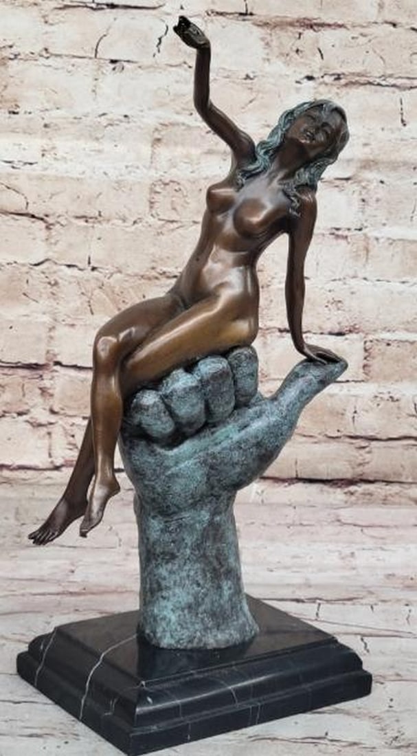 Abstract Nude Female on Hand Bronze Sculpture: Abstract Nude Female on Hand Bronze Sculpture Bold and imaginative, this abstract modern bronze sculpture features a nude female figure elegantly seated atop a large hand formed in a thumbs-up gesture