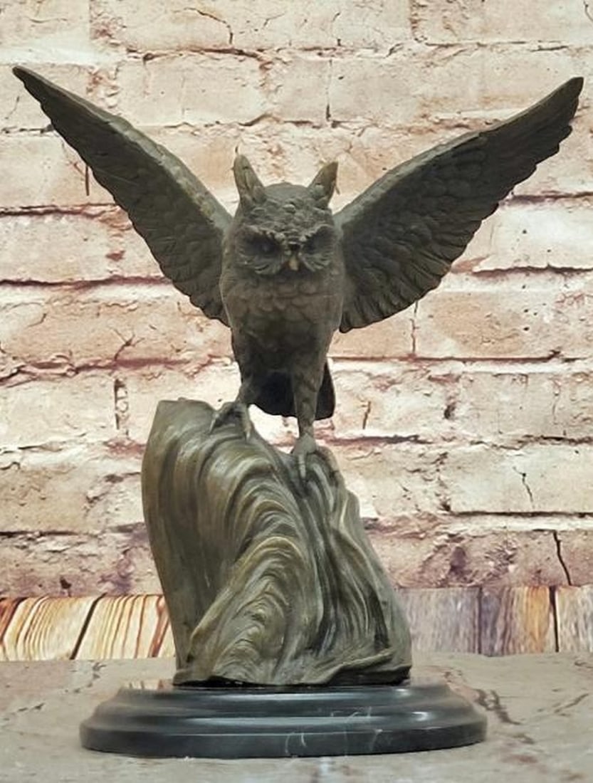 Bronze Owl with Outstretched Wings: Bronze Owl with Outstretched Wings This captivating bronze sculpture, bearing the signature of artist Nick, features an owl standing tall with its wings fully outstretched, capturing a moment of