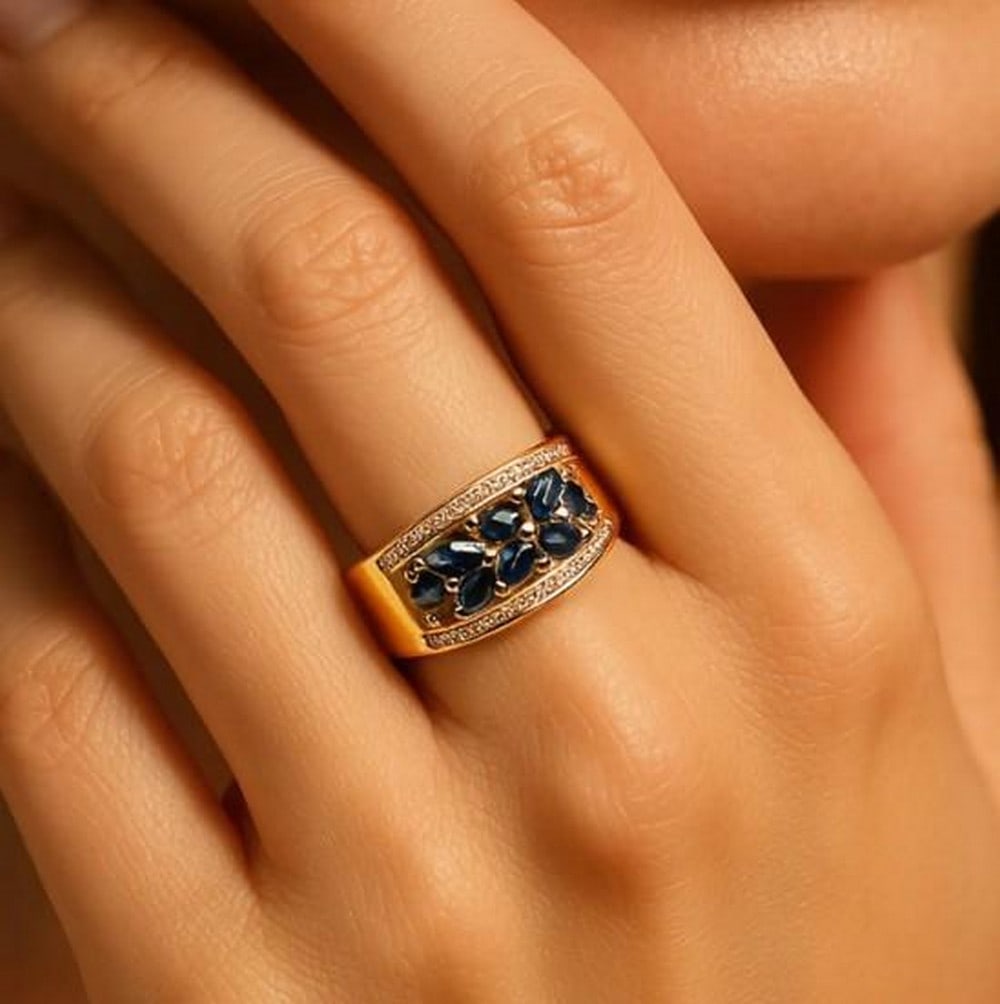 Royal Radiance: Royal Radiance - Blue Sapphire Marquise Ring Prepare to be captivated by the mesmerizing allure of this exquisite ring. At its heart lies a meticulously arranged array of deeply hued, marquise-cut