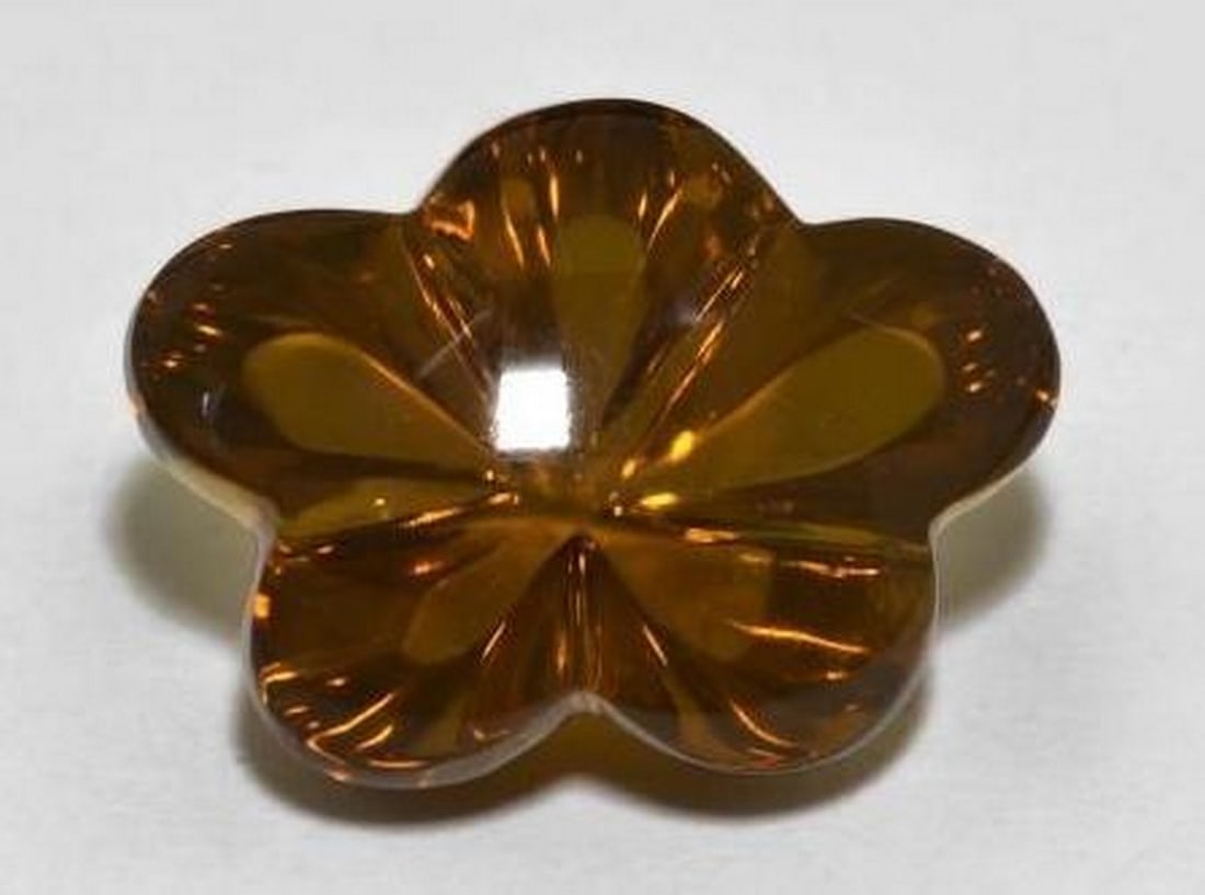 Dark Brown Smoky Quartz Carved Flower Gemstone: Dark Brown Smoky Quartz Carved Flower Gemstone This elegant loose gemstone is carved from deep, dark brown smoky quartz into the graceful form of a blooming flower. The rich, earthy tone enhances the