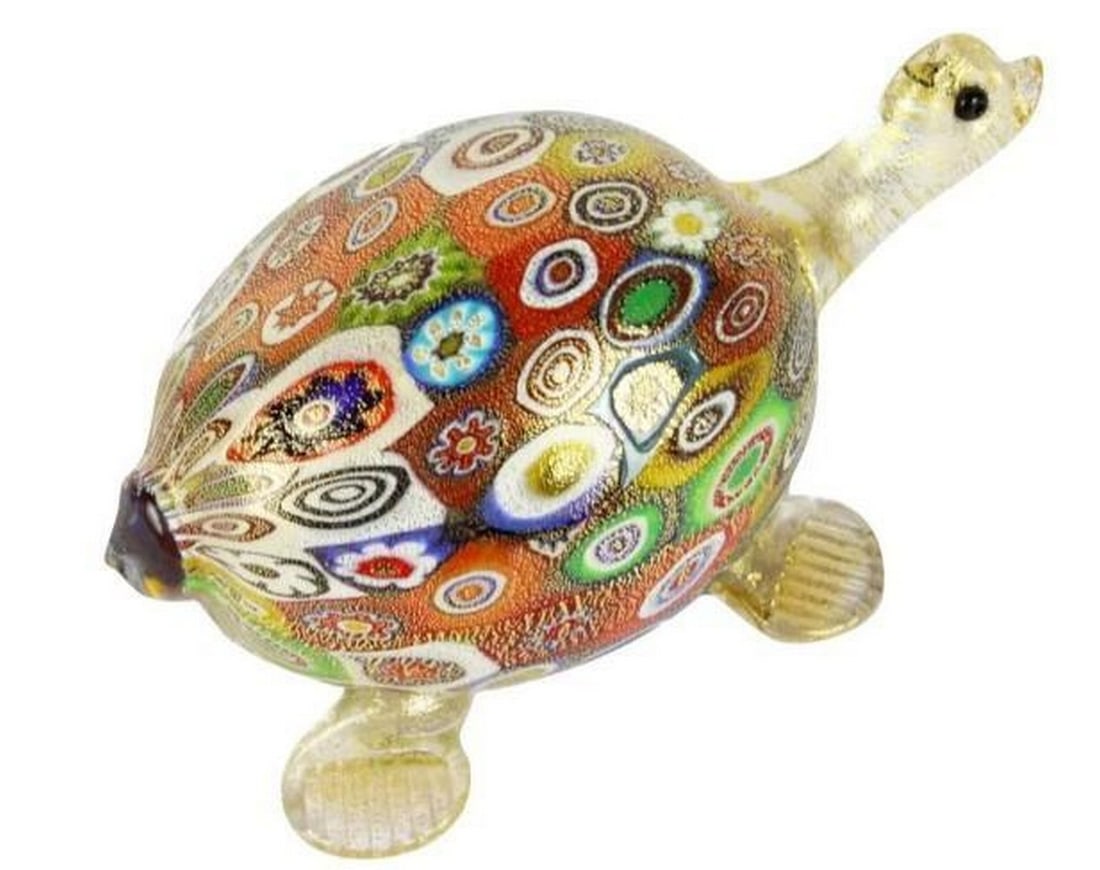 Millefiori Gold Turtle: Millefiori Gold Turtle This enchanting Murano glass turtle figurine blends the intricate beauty of millefiori patterns with radiant gold accents. Handcrafted with exquisite detail, its domed shell