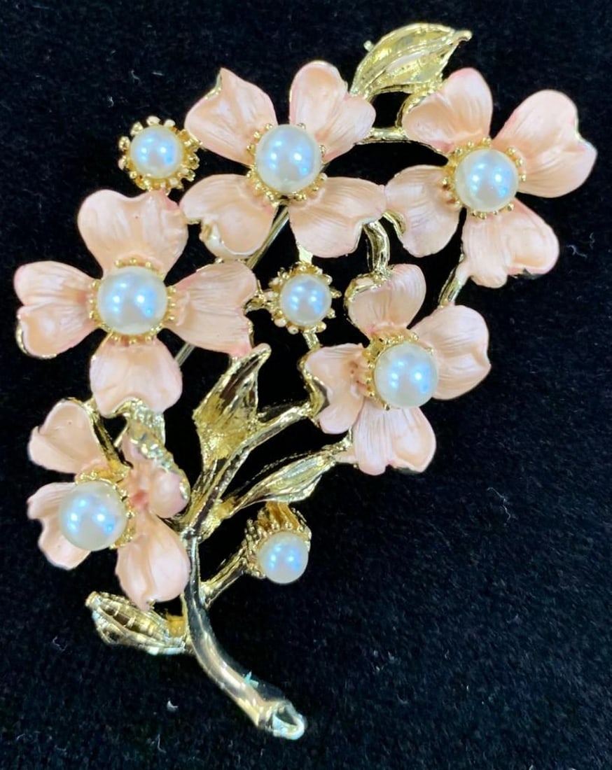 Coral Coloured Floral Brooch with Inlaid White Pearl Accents: Coral Coloured Floral Brooch with Inlaid White Pearl Accents White pearls are thought to symbolize innocence, new beginnings, beauty and sincerity. They have also been said to signify femininity, puri