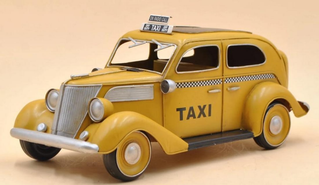 Curbside Icon: Curbside Icon Crafted from durable plastic and die-cast metal, this sculpture captures the timeless form of a yellow taxi cab, an enduring icon of city streets and fast-paced lives. With its vivid col