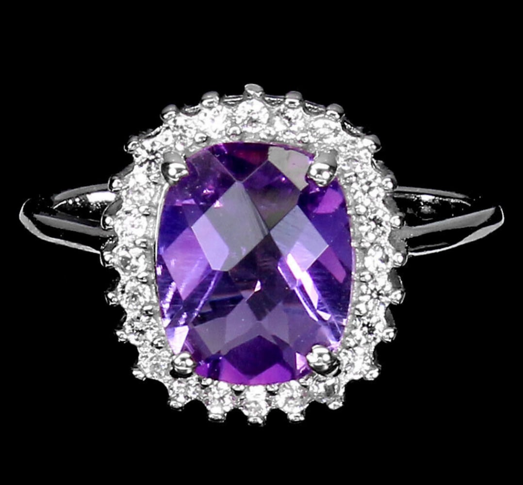 Amethyst and White Zircon Sterling Silver Ring - Size 7: Amethyst and White Zircon Sterling Silver Ring - Size 7 The focal point of the ring is the exquisite amethyst, renowned for its deep purple hue and captivating allure. Its rich color evokes the