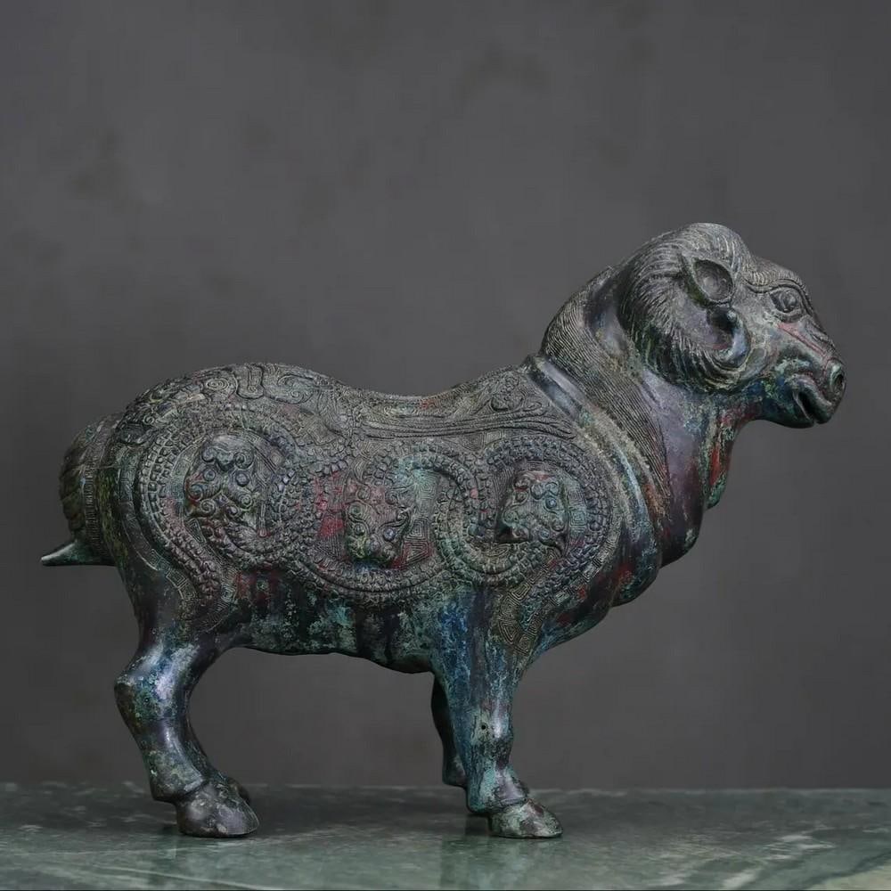 Antique Chinese Bronze Sheep Statue: Antique Chinese Bronze Sheep Statue This rare hand-crafted statue showcases traditional Chinese artistry, featuring a finely sculpted sheep made from bronze. The detailed craftsmanship highlights the