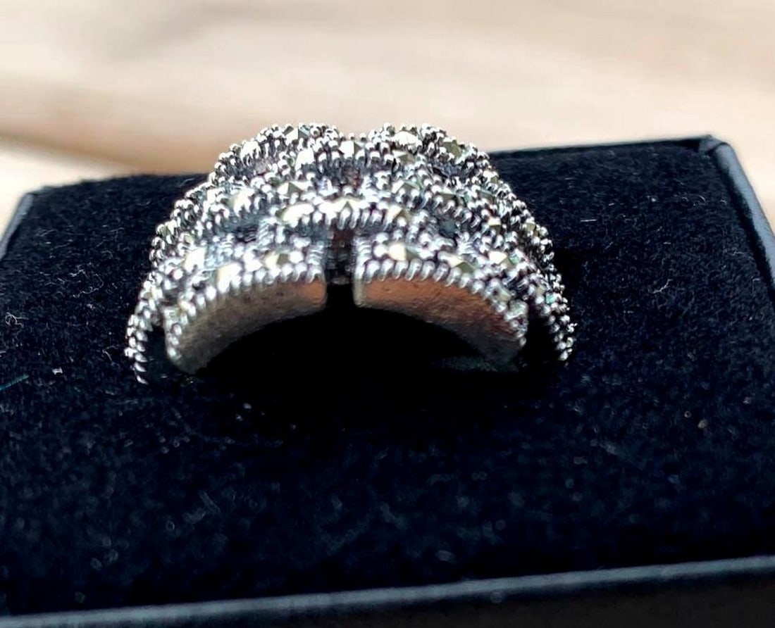Sterling Silver Basket Weave Ring with Dark Stone Accents: Sterling Silver Basket Weave Ring with Dark Stone Accents Rich in texture and subtle elegance, this sterling silver ring features a detailed basket weave design adorned with scattered dark stones. The