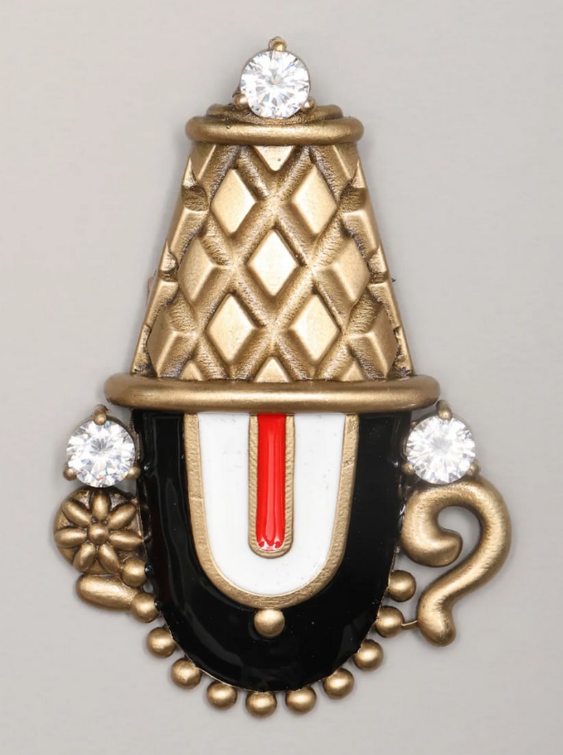 Divine Lord Balaji Stone-Studded Brooch: Divine Lord Balaji Stone-Studded Brooch This Lord Balaji brooch blends spiritual elegance with intricate craftsmanship, featuring detailed design and a gleaming stone. Measuring 2.7 inches by 1.75