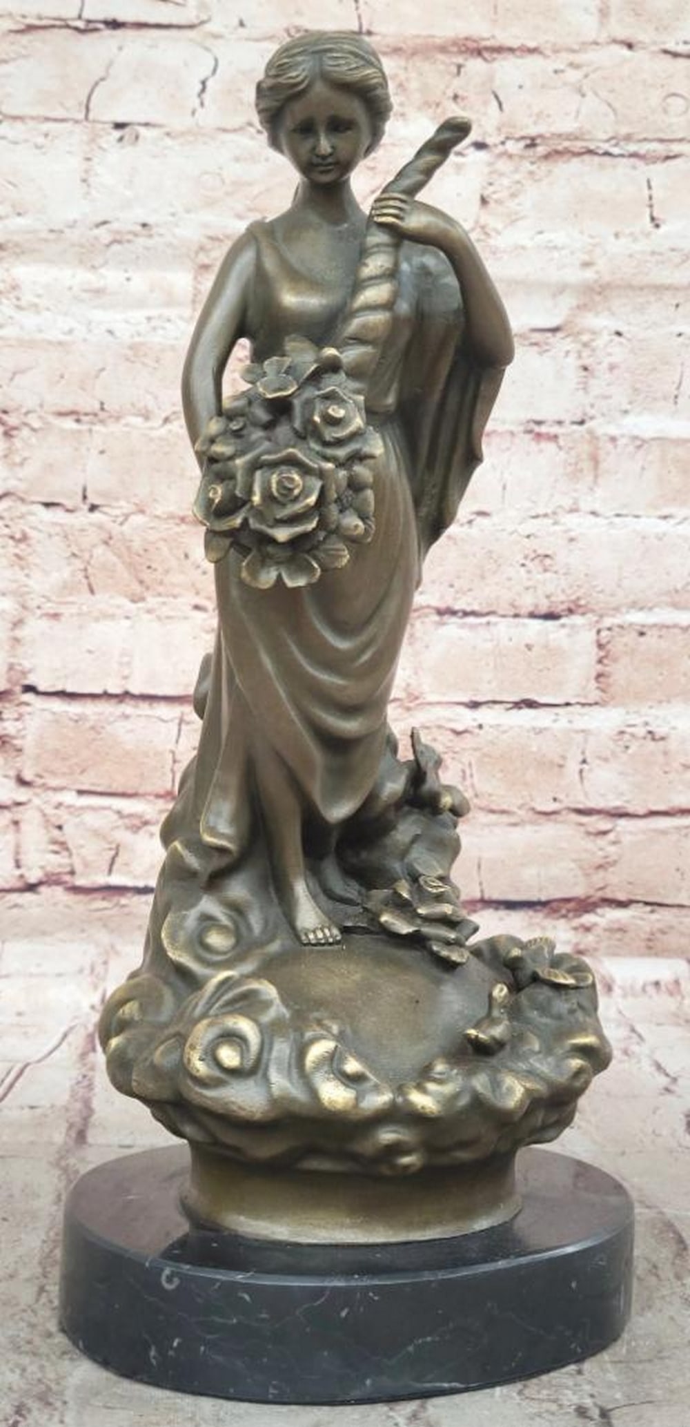 Bronze Sculpture of Woman with Flower Cornucopia by Milo - 13" x 6": Bronze Sculpture of Woman with Flower Cornucopia by Milo - 13" x 6" This handcrafted bronze sculpture by Milo showcases a graceful woman holding a flower-filled cornucopia, symbolizing feminin