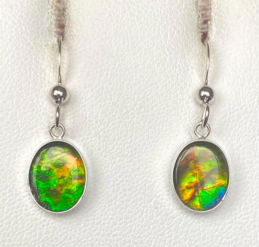 Deep Green Ammolite Earrings: Deep Green Ammolite Earrings These Ammolite earrings showcase rich autumn hues with a beautifully crinkled pattern. The 10mm x 8mm low-dome quartz-capped triplets are set in sterling silver and hang f