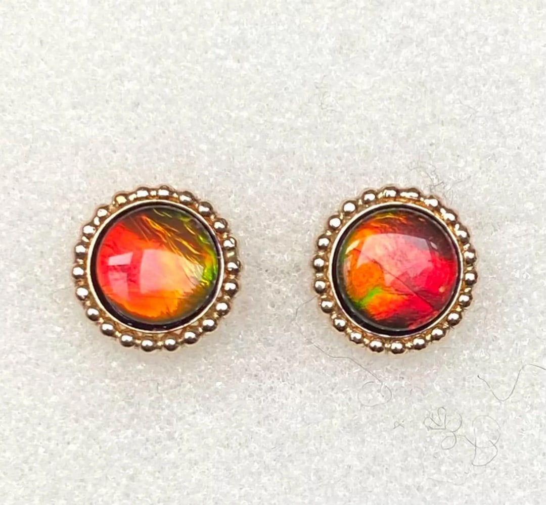 Ammolite Stud Earrings: Ammolite Stud Earrings This pair of Ammolite stud earrings features vibrant 8mm triplet gemstones with a striking flash and a color shift to green at extreme angles, as shown in the photo. Set in dura