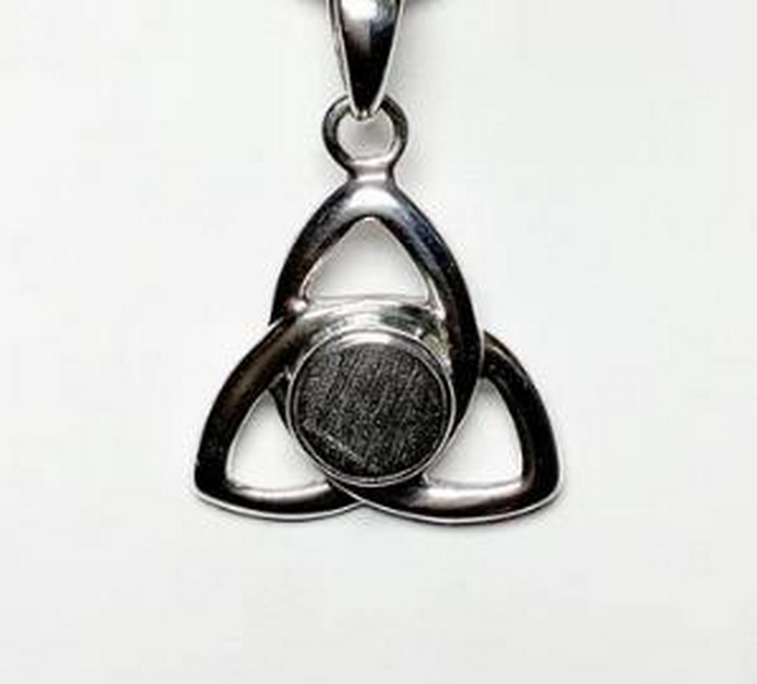 Muonionalusta Meteorite Set In Sterling Silver Celtic Knot Pendant: Muonionalusta Meteorite Set In Sterling Silver Celtic Knot Pendant. Ancient and awe-inspiring, this pendant carries the energy of the cosmos. Estimated to be over 4.5 billion years old (and is believe