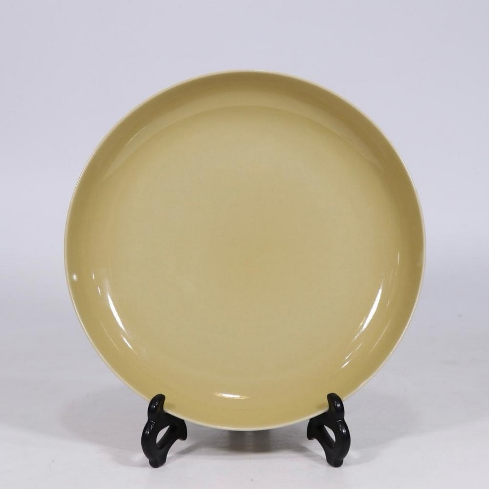 Qing Dynasty Yongzheng Delicate Yellow Glaze Plate: Qing Dynasty Yongzheng Delicate Yellow Glaze Plate A finely crafted porcelain plate from the Yongzheng period of the Qing Dynasty, finished in a soft, delicate yellow glaze. The smooth, lustrous surfa