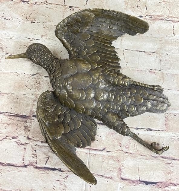 Wings of Time: Bronze Flying Bird Wall Sculpture: Wings of Time: Bronze Flying Bird Wall Sculpture Gracefully suspended in mid-flight, this vintage cast wall hanging bronze captures the timeless beauty of a bird soaring through the air. It is bearing