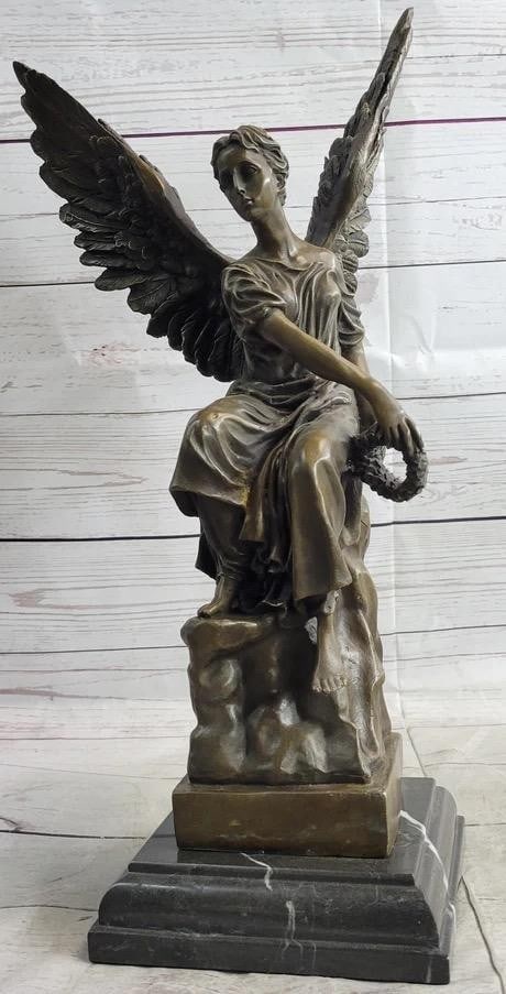 Seated Angel Holding Wreath Inspired Bronze Statue - 17'' X 9'': Seated Angel Holding Wreath Inspired Bronze Statue - 17" X 9" Gracefully poised with divine intent, this bronze sculpture beautifully embodies the essence of a guardian angel engaged in celestia