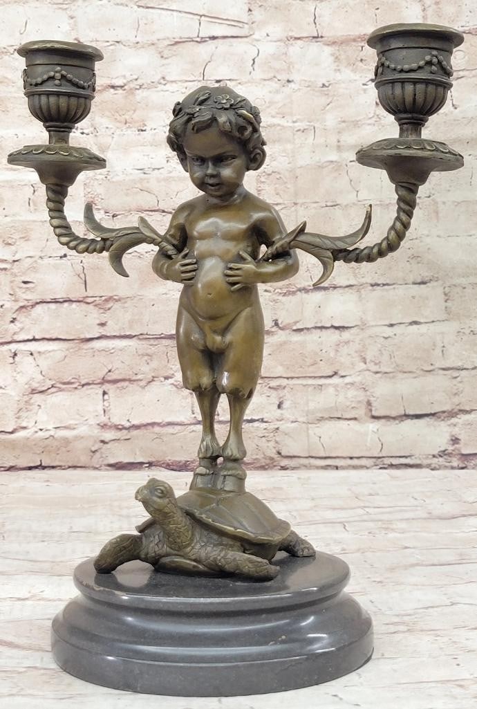 Baby Satyr Candelabrum Bronze Sculpture by Aldo Vitaleh - 13'' x 9'': Baby Satyr Candelabrum Bronze Sculpture by Aldo Vitaleh - 13" x 9" Introducing a whimsical bronze sculpture of a baby satyr, artfully designed to hold a charming candelabrum. With his hoofs grac