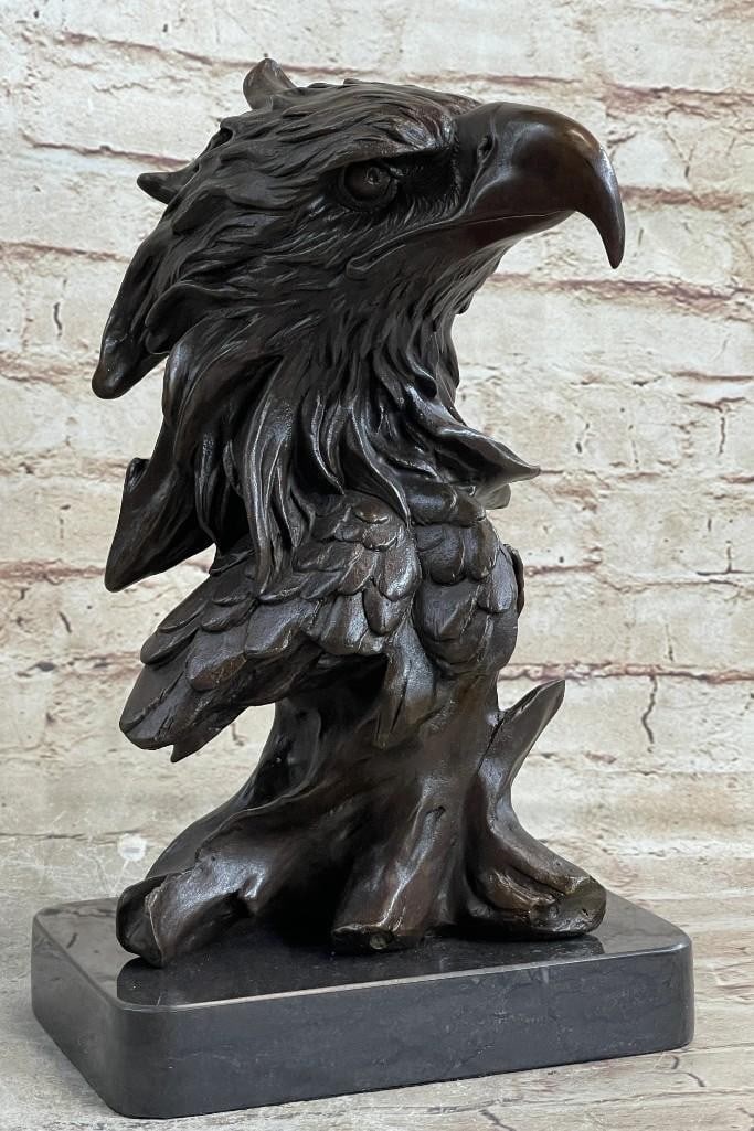 American Eagle Perched On Tree Bronze Sculpture: American Eagle Perched On Tree Bronze Sculpture The bust of the eagle head captures the essence of the majestic bird of prey. The eagles very large hooked beak (coated in a gold patina) is used for te
