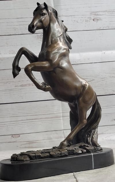 Rearing Horse Bronze Statue: Rearing Horse Bronze Statue Full of energy and motion, this bronze metal statue depicts a rearing horse in a moment of wild strength and spirited defiance. With finely detailed musculature and flowing