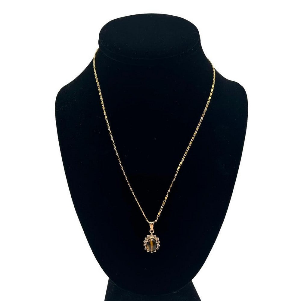 Tiger's Eye Center Stone CZ Pendant Necklace: Tigers Eye Center Stone CZ Pendant Necklace This pendant combines the brilliance of cubic zirconia (CZ) stones with the natural beauty of a tigers eye centerpiece, creating a truly mesmerizing