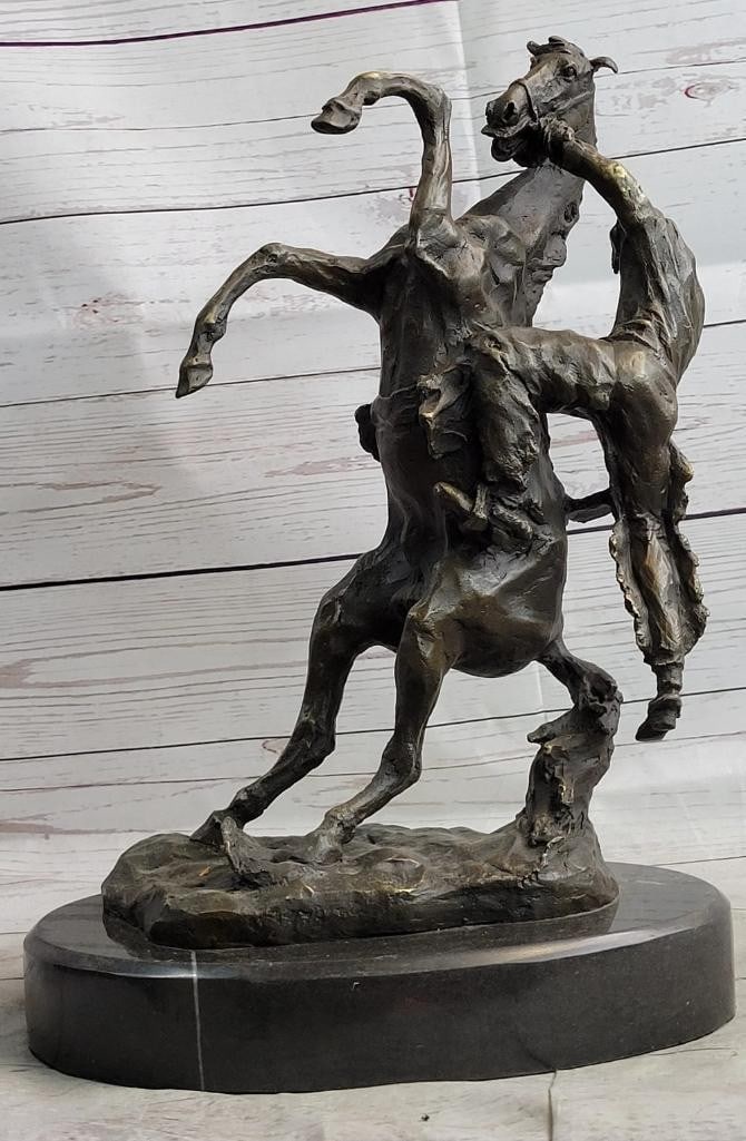 Cowboy Bucked off Horse Inspired Bronze Statue - 15'' x 10'': Cowboy Bucked off Horse Inspired Bronze Statue - 15" x 10" This bronze statue vividly captures the thrilling moment of a cowboy being bucked off a horse. The horse is dramatically reared up on i