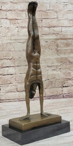 Balance of Power: Nude Male Handstand Bronze Sculpture: Balance of Power: Nude Male Handstand Bronze Sculpture A striking tribute to human strength and control, this sculpture captures a nude, muscular male figure frozen in an elegant handstand. Cast in br